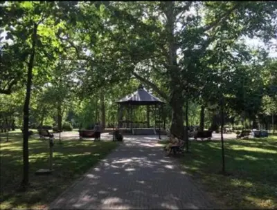 a path in a park with a gazebo at Royal Residence aprtamani Aviv in Pančevo
