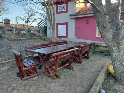 a wooden picnic table in front of a house at Ranč Petar Alavanja Banstol in Sremski Karlovci