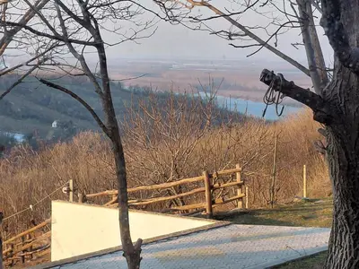 a wooden fence with a view of a lake at Ranč Petar Alavanja Banstol in Sremski Karlovci