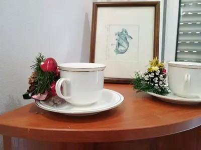 two cups and plates on a table with christmas decorations at H1trece in Belgrade