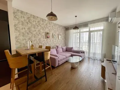 a living room with a purple couch and a table at Romantic One Bedroom Home at BW-City and Park View in Belgrade