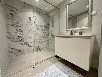 a white bathroom with a sink and a shower at Romantic One Bedroom Home at BW-City and Park View in Belgrade