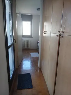 a room with a hallway with a door and a window at Apartman86 in Beograd