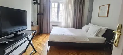 a bedroom with a bed and a flat screen tv at Two Bedroom Apartment Obilicev Venac in Belgrade