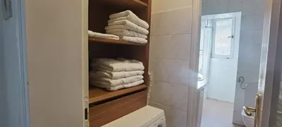 a bathroom with a towel rack with towels at Two Bedroom Apartment Obilicev Venac in Belgrade