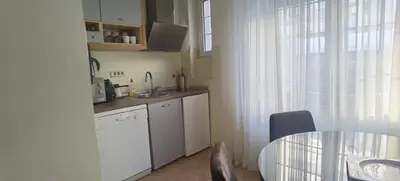 a kitchen with a sink and a table and a window at Two Bedroom Apartment Obilicev Venac in Belgrade