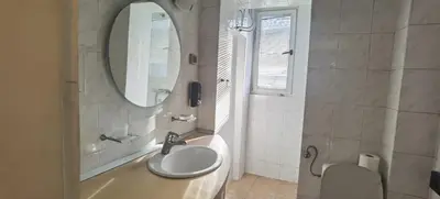a bathroom with a sink and a shower with a mirror at Two Bedroom Apartment Obilicev Venac in Belgrade