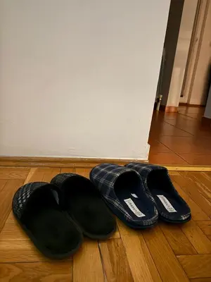 two pairs of shoes sitting on a wooden floor at Barbello in Stara Pazova