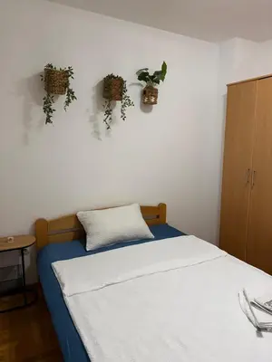 a bedroom with a bed with plants on the wall at Barbello in Stara Pazova