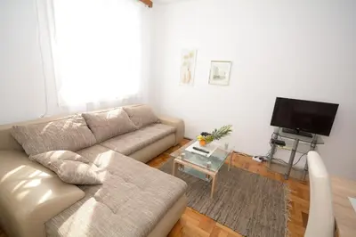 a living room with a couch and a tv at Apartments City Hall in Belgrade