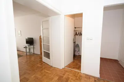 a room with white walls and a wooden floor at Apartments City Hall in Belgrade
