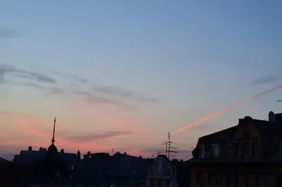 a city skyline with a sunset in the sky at casa CIUK in Belgrade