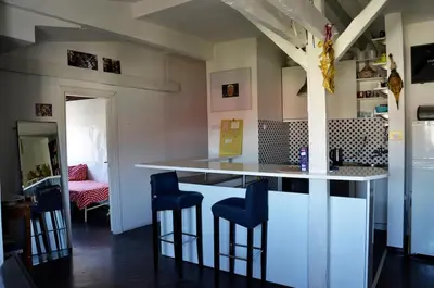 a kitchen with a bar with blue stools at casa CIUK in Belgrade