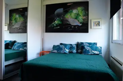 a bedroom with a bed with a green comforter at casa CIUK in Belgrade
