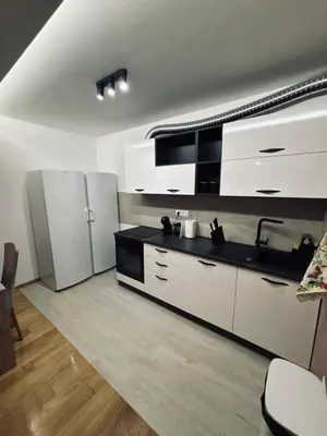 a kitchen with white cabinets and a stainless steel refrigerator at No 104 7 Residance in Belgrade