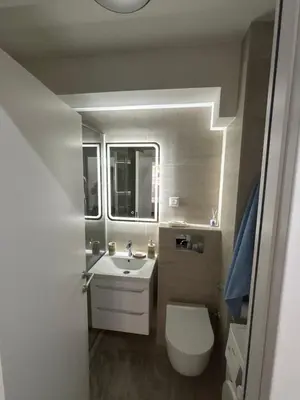 a bathroom with a white toilet and a sink at No 104 7 Residance in Belgrade