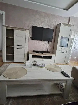 a living room with a table and a tv at No 104 7 Residance in Belgrade