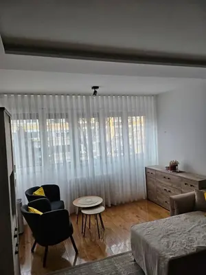 a living room with a bed and chairs and a table at No 104 7 Residance in Belgrade