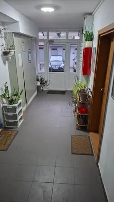 a hallway with a car parked in a garage at Jelena's place in Belgrade
