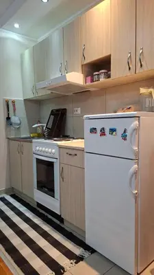 a kitchen with a stove and a white refrigerator at Jelena's place in Belgrade