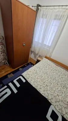 a bedroom with a bed and a window at Jelena's place in Belgrade