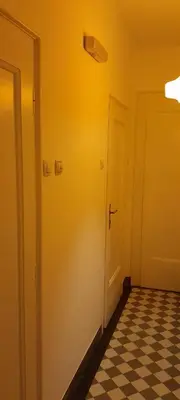 a hallway with a door and a checkered floor at Flat center of Belgrade in Belgrade