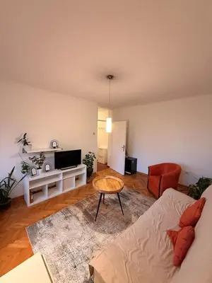 a living room with a couch and a table at Light & Cozy Flat Banovo Brdo in Belgrade