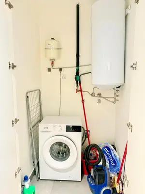 a laundry room with a washing machine in it at Eden Apratment in Belgrade