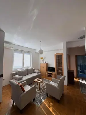 a living room with a couch and two chairs at Cozy place in Belgrade