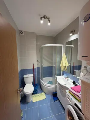 a bathroom with a toilet and a tub and a sink at Cozy place in Belgrade