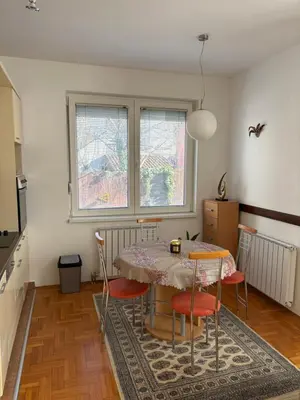 a dining room with a table and four chairs at Cozy place in Belgrade