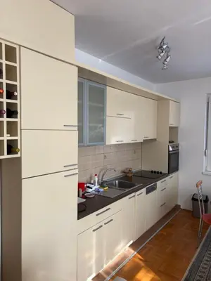 a kitchen with white cabinets and a sink at Cozy place in Belgrade