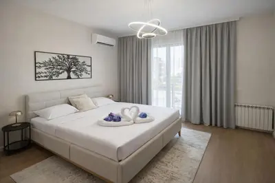 a bedroom with a bed with two swans on it at BW Sole Presidential Suite in Belgrade