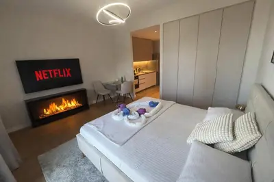 a living room with a bed and a fireplace at BW Sole Presidential Suite in Belgrade