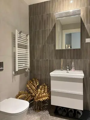 a bathroom with a sink and a toilet and a mirror at BW Sole Presidential Suite in Belgrade