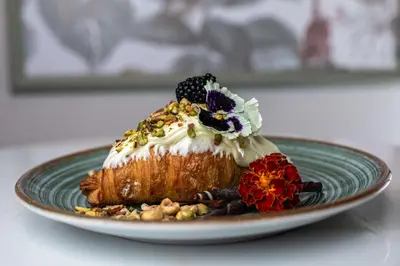 a dessert on a green plate on a table at BW Sole Presidential Suite in Belgrade