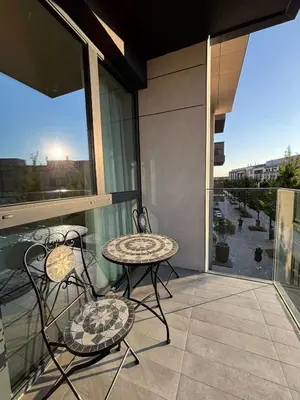 a balcony with a table and chairs on a balcony at BW Sole Presidential Suite in Belgrade