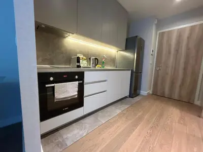 a kitchen with a stove and a refrigerator at BW Sole Presidential Suite in Belgrade