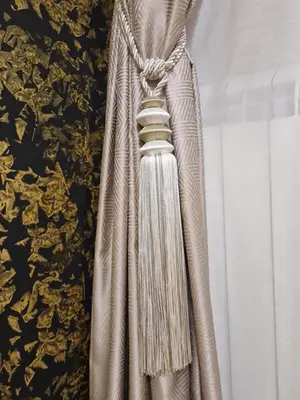 a dress hanging on a wall next to a curtain at Apartman Oskar Dunav in Stari Banovci