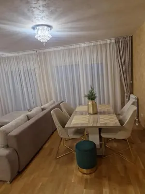 a living room with a couch and a table at Apartman Oskar Dunav in Stari Banovci