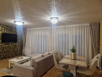 a living room with a couch and a table at Apartman Oskar Dunav in Stari Banovci