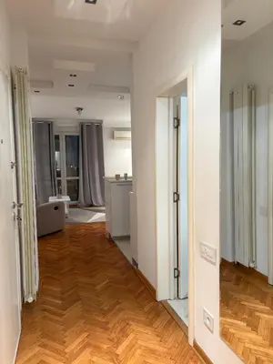 an empty room with wooden floors and white walls at Apartman Sasha 3 - Free parking in Belgrade