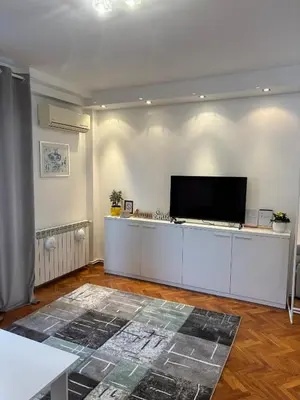 a living room with a flat screen tv on a wall at Apartman Sasha 3 - Free parking in Belgrade