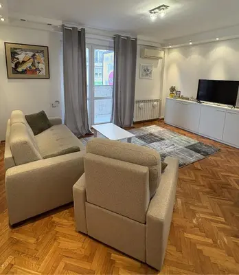 a living room with two couches and a tv at Apartman Sasha 3 - Free parking in Belgrade
