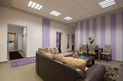 a living room with a couch and a dining room at Apartment Vukanja in Belgrade