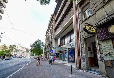 a group of people walking down a sidewalk on a city street at Apartment Vukanja in Belgrade