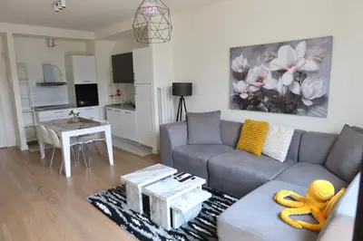 a living room with a couch and a table at Beograd na vodi Belgrade waterfront - Great city view in Belgrade