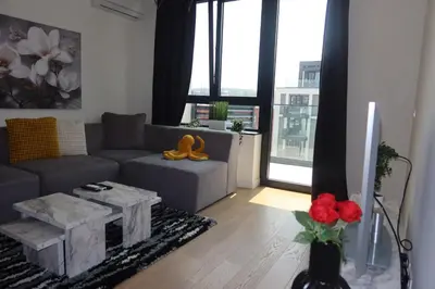 a living room with a couch and a table at Beograd na vodi Belgrade waterfront - Great city view in Belgrade