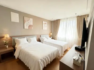 a hotel room with two beds and a television at Sky Vista Hotel in Ledine