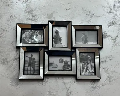 a group of picture frames hanging on a wall at Sky Vista Hotel in Ledine